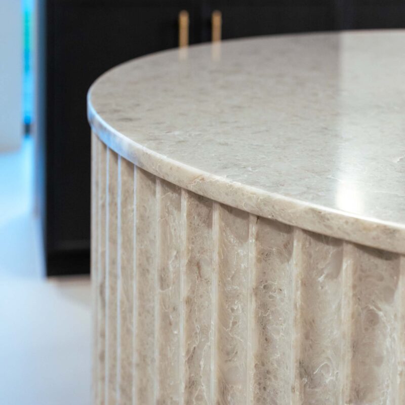 Fluted stone curved island benchtop.
