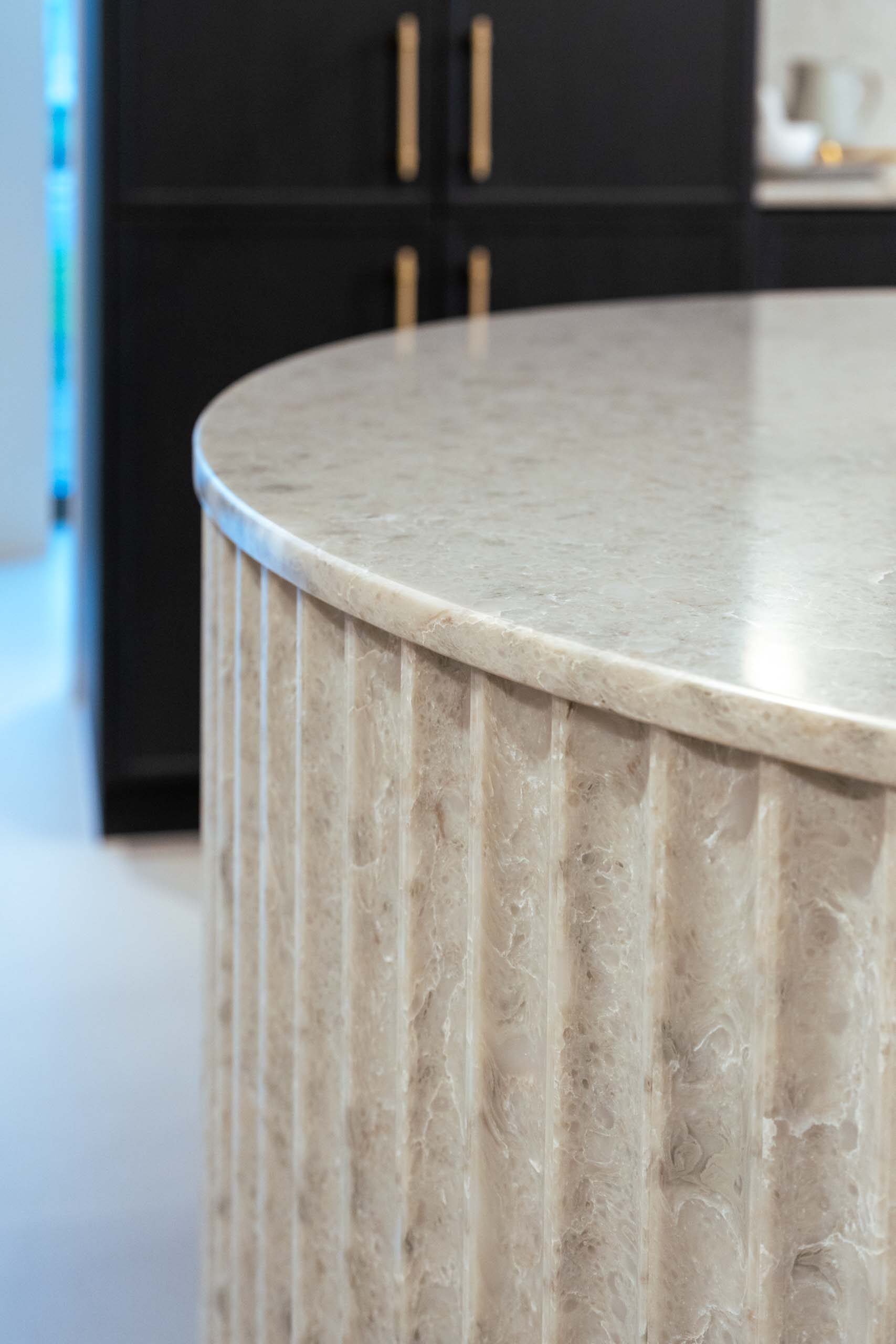 Fluted stone curved island benchtop.