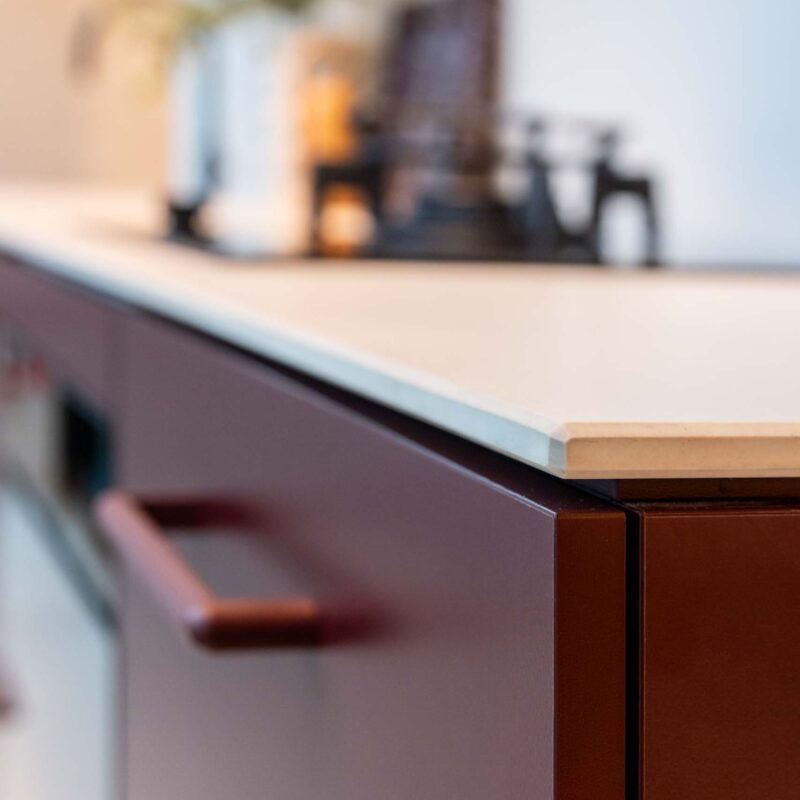 Small kitchen with Kalamata laminate cabinets and a light 12mm Dekton Aeris benchtop.